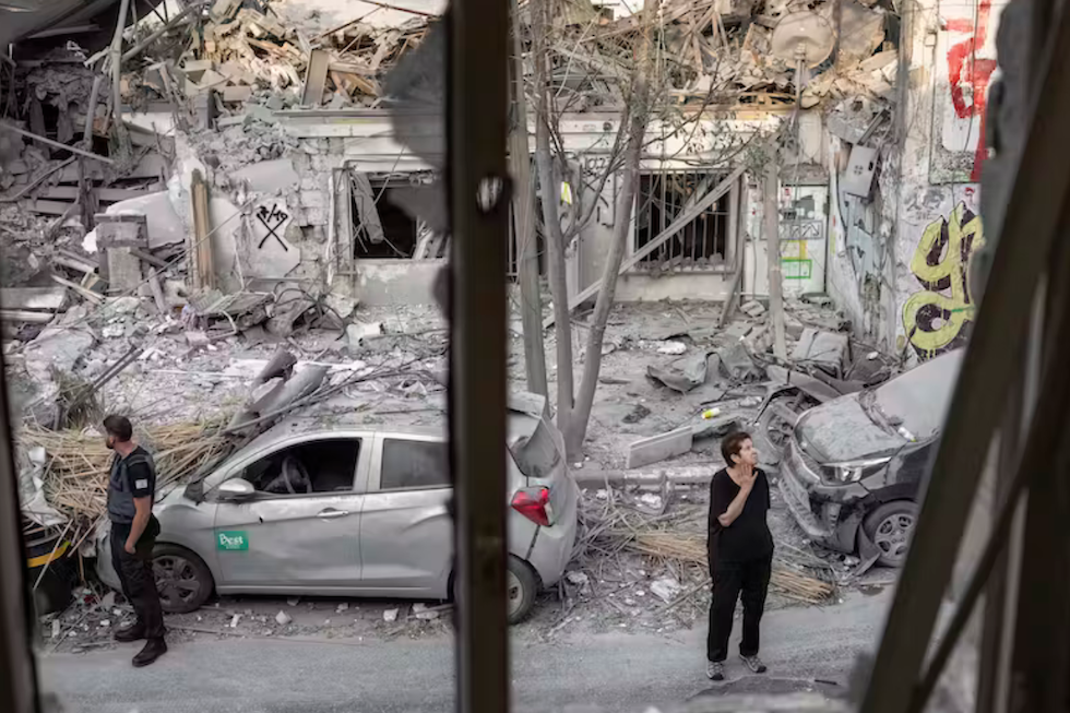 Israelis inspect the rubble of a building in Tel Aviv on Oct. 8, 2023, a day after it was hit by a rocket fired from the Gaza Strip. AP Photo/Oded Balilty